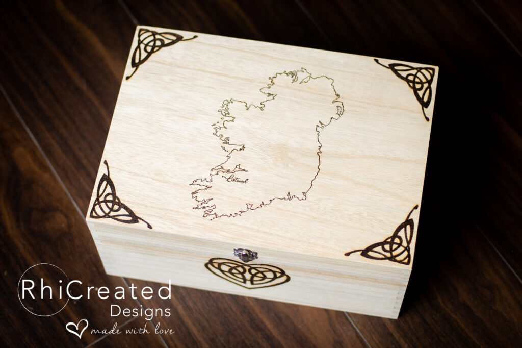 Wood burned, wooden keepsake box with Ireland on front and celtic designs in the corner